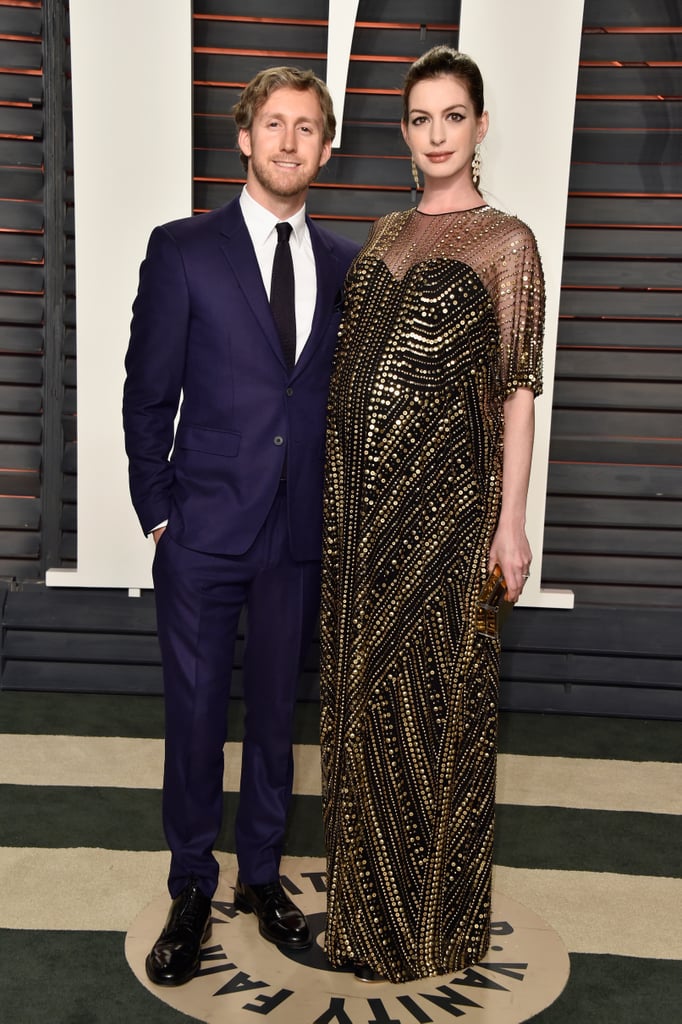 Anne Hathaway made a dazzling appearance with husband Adam Shulman at Vanity Fair's annual Oscars afterparty on Sunday night. The actress, who is pregnant with her first child, was positively glowing while showing off her baby bump from all angles on the red carpet. Anne is also back to being a brunette after debuting blond locks earlier this month. Read on to see more of Anne's blossoming belly, and then check out this epic throwback photo of her as a child.