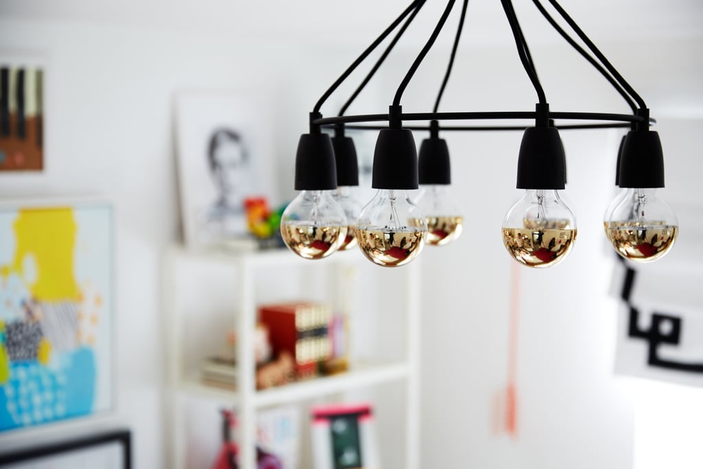 The original ceiling fixture was replaced with a mod glowing chandelier that channels Coco's sleek style. It was put on a dimmer for a softer effect.