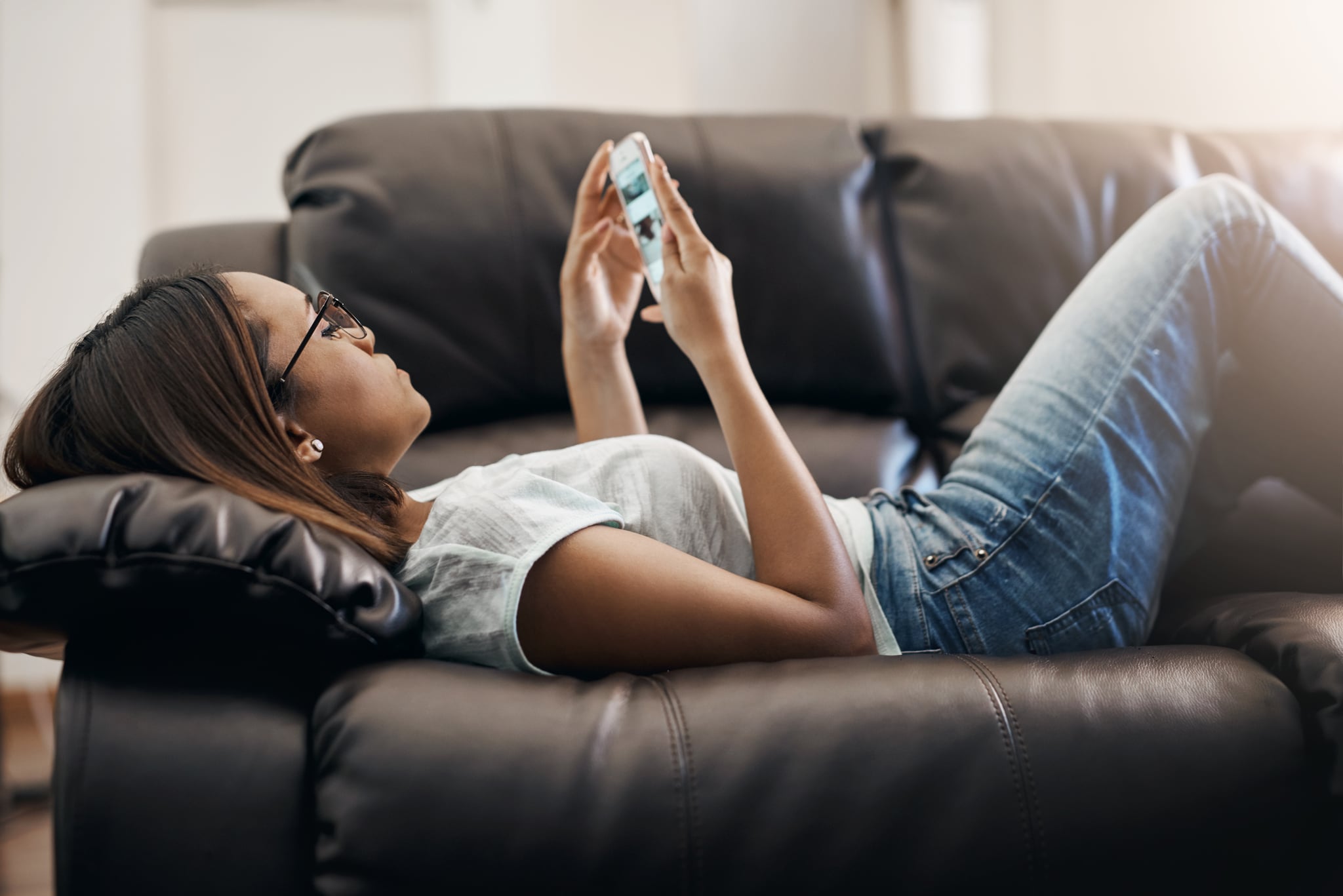 Cropped shot of an attractive young woman using a cellphone at home