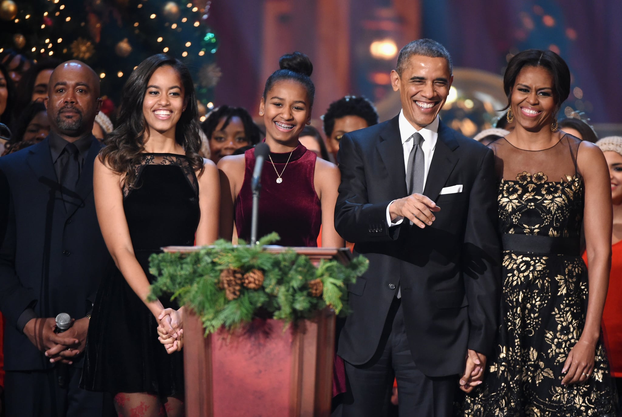 WASHINGTON, DC - DECEMBER 14:  (L-R) Darius Rucker, Malia Obama, Sasha Obama, U.S. President Barack Obama, and First Lady Michelle Obama speak onstage at TNT Christmas in Washington 2014 at the National Building Museum on December 14, 2014 in Washington, DC.  25248_001_0605.JPG  (Photo by Theo Wargo/WireImage)