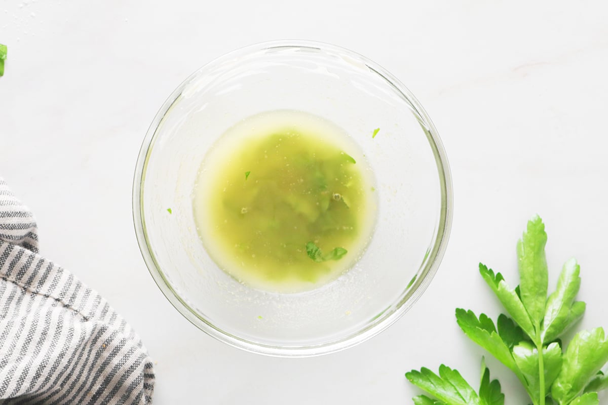 Melted butter and parsley in a bowl