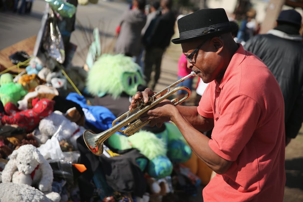 A man played a trumpet at Michael Brown's memorial.