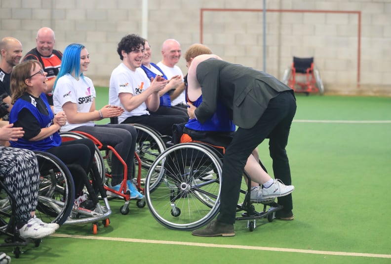 Harry hugged a member of the Lancashire Bombers Wheelchair Basketball Club in 2017.