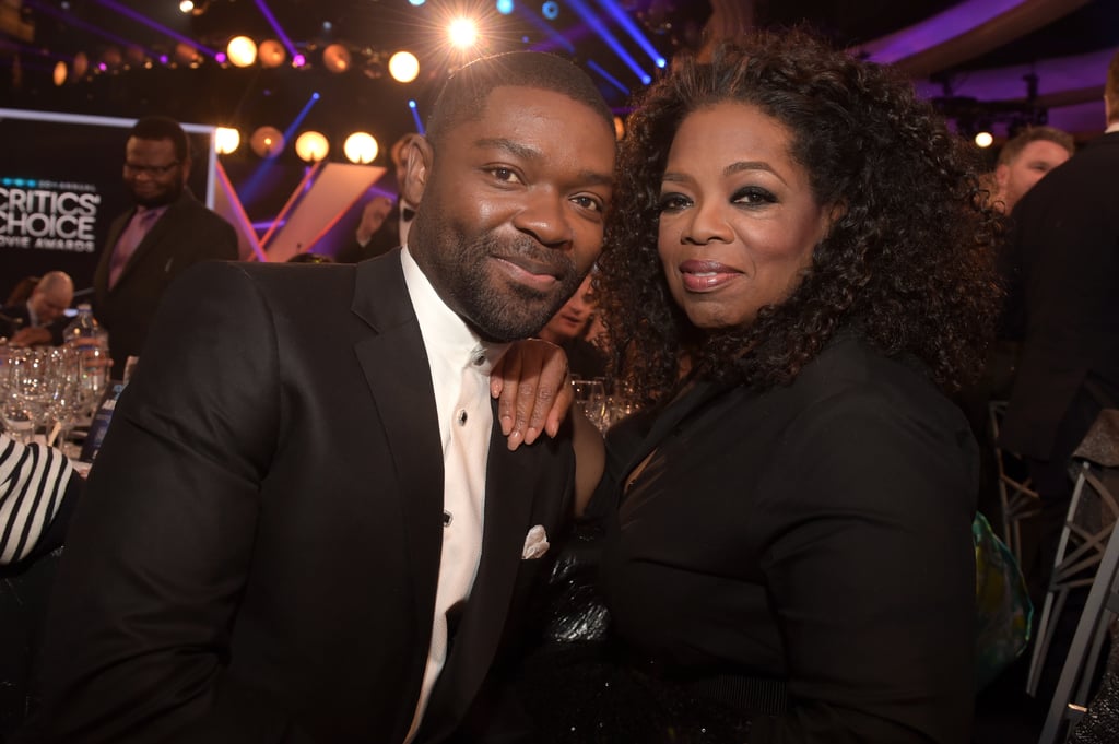 David Oyelowo and Oprah Winfrey posed for a photo at their table.