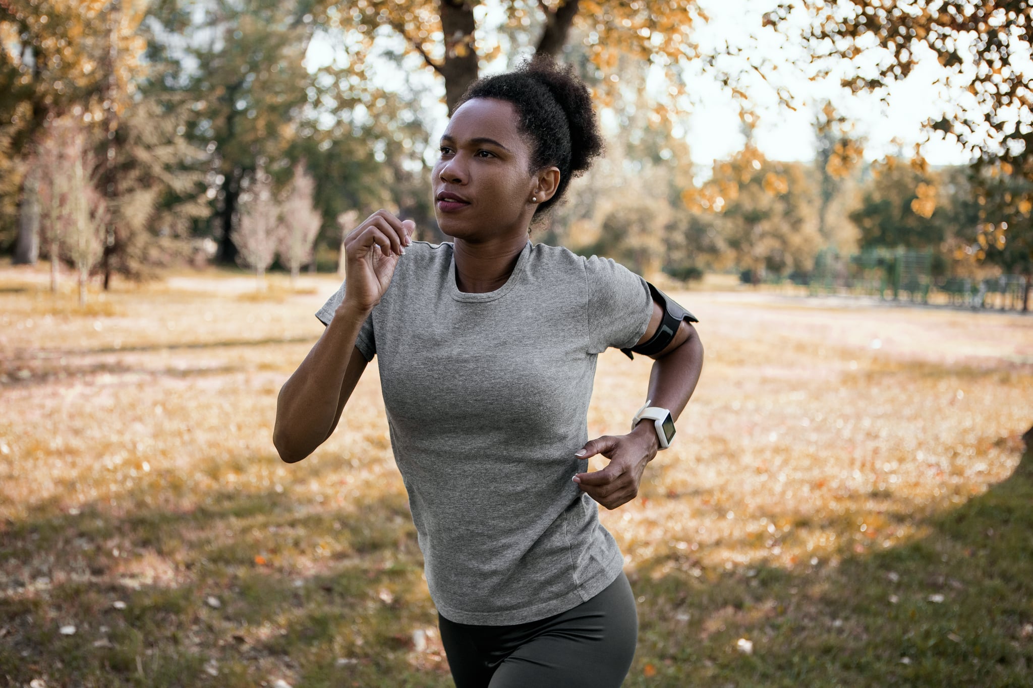 African American female athlete running in the public park