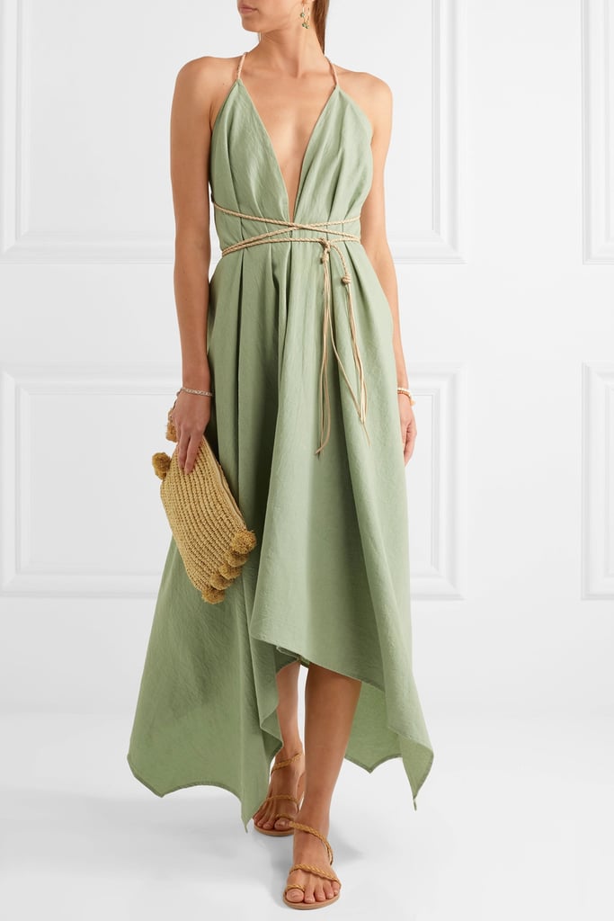 You'll need one standout vacation dress for dreamy dinners on the beach. The Caravana — Yatzil Asymmetric Leather-Trimmed Cotton Maxi Dress — Gray Green ($300) is the perfect option.