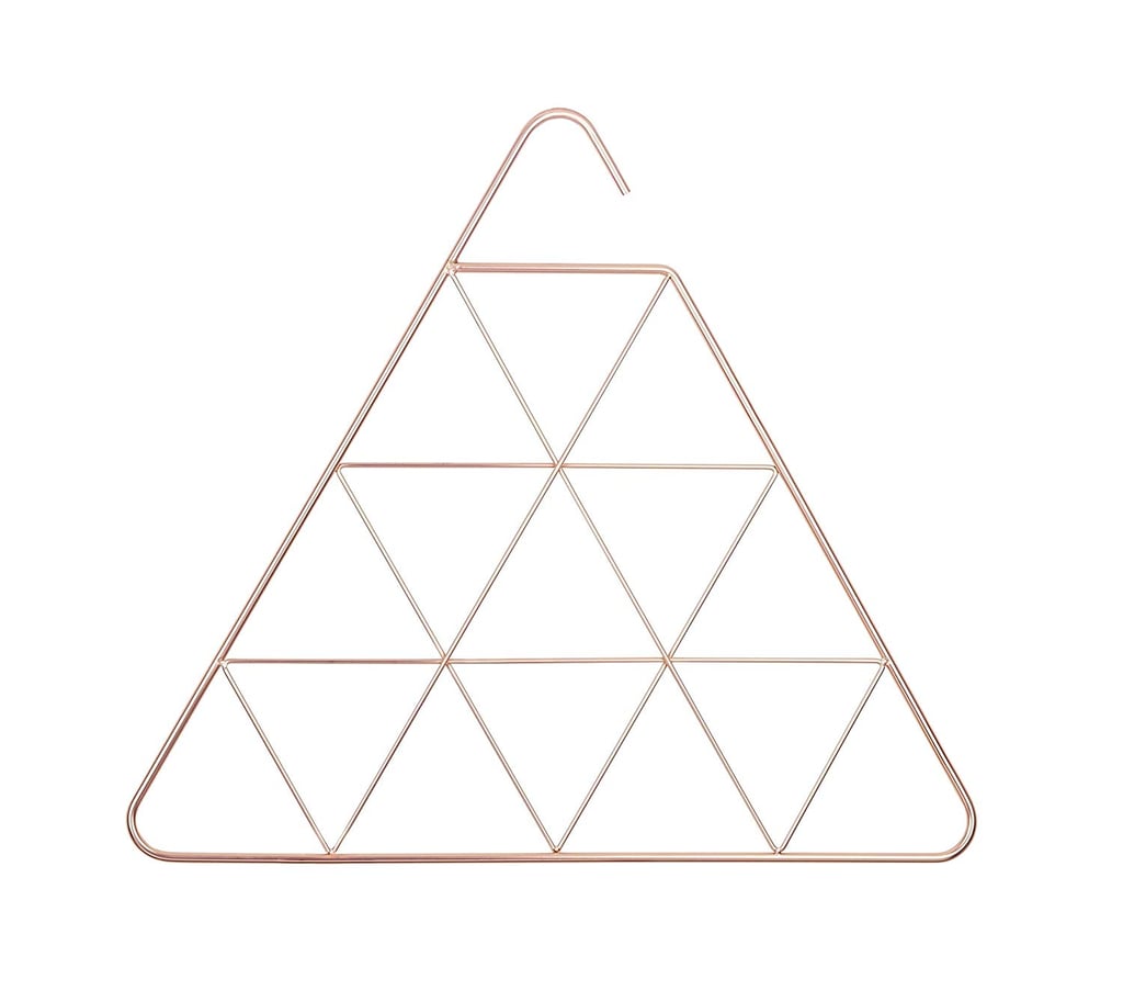 If you're not willing to compromise aesthetics, consider buying the Umbra Pendant Triangular Copper Scarf Hanger ($15). The geometric copper design is as trendy as it is functional.