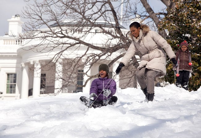 The first lady helping Malia sled down a hill on the South Lawn during one of the capital's snowstorms.