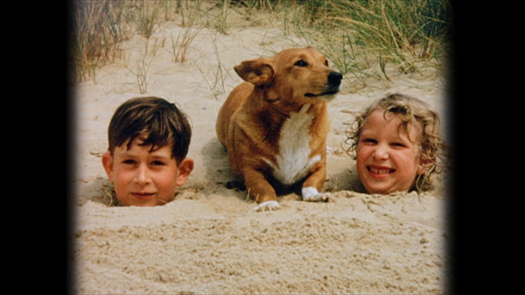 A young Prince Charles and Princess Anne got silly in the sand with one of the queen's Corgis in 1957.