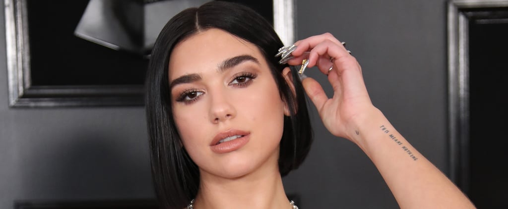 Dua Lipa Wore a Sleek Black Catsuit Covered in Teardrop Cutouts (and Holographic Slides!)