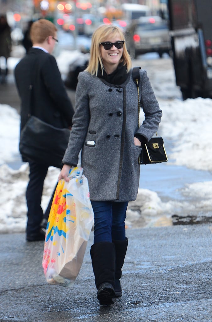 While visiting NYC, Reese bundled up in a tweed coat and black shearling boots.