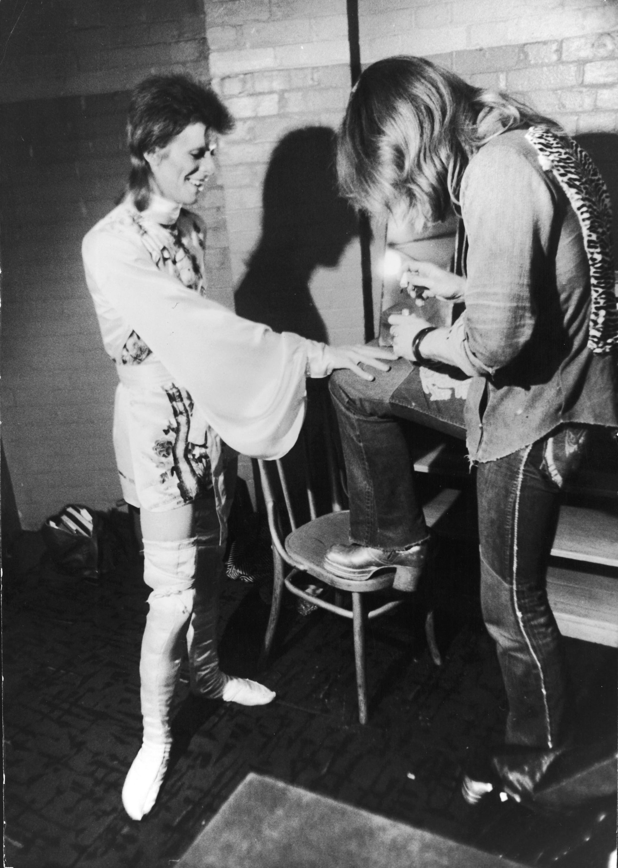 Make-up artist Pierre La Roche prepares English singer David Bowie for a performance as Aladdin Sane, 1973. Bowie is wearing a costume by Japanese designer Kansai Yamamoto. (Photo by Daily Express/Hulton Archive/Getty Images)