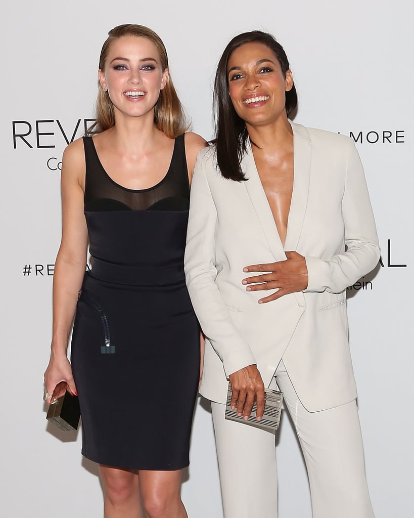 Amber Heard and Rosario Dawson shared a laugh at the Reveal Calvin Klein fragrance launch party on Monday night.