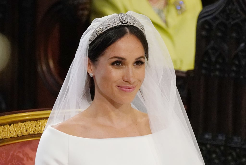 Meghan kept her five-meter-long wedding veil in place with a diamond-encrusted bandeau tiara, which originally belonged to Queen Mary and was lent to her for the special occasion.