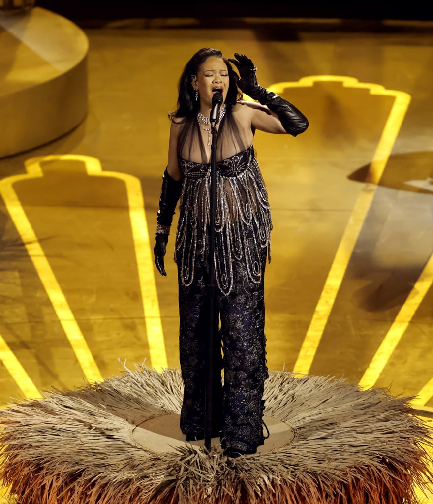 Rihanna just reminded fans, once again, that she absolutely commands the stage. The 35-year-old singer performed her Oscar-nominated single "Lift Me Up" from the "Black Panther: Wakanda Forever" soundtrack during the March 12 ceremony. Sparkling in a black and crystal top with trousers and long latex gloves, the performer slowly rose up — as the song suggests — on a platform in the center of the Dolby Theatre stage, backed by gospel singers and a live orchestra.
As the pregnant singer concluded the song, the cameras cut to her partner, A$AP Rocky, in the audience, who raised his Champagne glass in a toast.
Rihanna was up for best original song against Sofia Carson ("Applause" from "Tell It Like a Woman"), Lady Gaga ("Hold My Hand" from "Top Gun: Maverick"), Ryan Lott, David Byrne, and Mitski ("This Is a Life" from "Everything Everywhere All at Once"), and Rahul Sipligunj and Kaala Bhairava ("Naatu Naatu" from "RRR"), who ended up taking the award home. The nod marks Rihanna's first-ever Oscar nomination.
This year is shaping up to be a big one for Rihanna. In addition to her debut performance at the Oscars, she recently headlined the Super Bowl LVII halftime show, where she revealed she's expecting her second child with Rocky.
On top of that, Rihanna is also back in the studio working on new music. "Im feeling open to exploring, discovering, creating things that are new, things that are different, things that are off, weird, might not ever make sense to my fans and the people that know the music I put out," the superstar said during her press conference with Apple Music on Feb. 9. "I just want to play. I want to have fun with music."
Scroll ahead to watch Rihanna's sparkling performance at the 2023 Oscars.
Related:
Rihanna Says Parenthood Brought Her and A$AP Rocky "Closer": "We&apos;re Best Friends With a Baby"