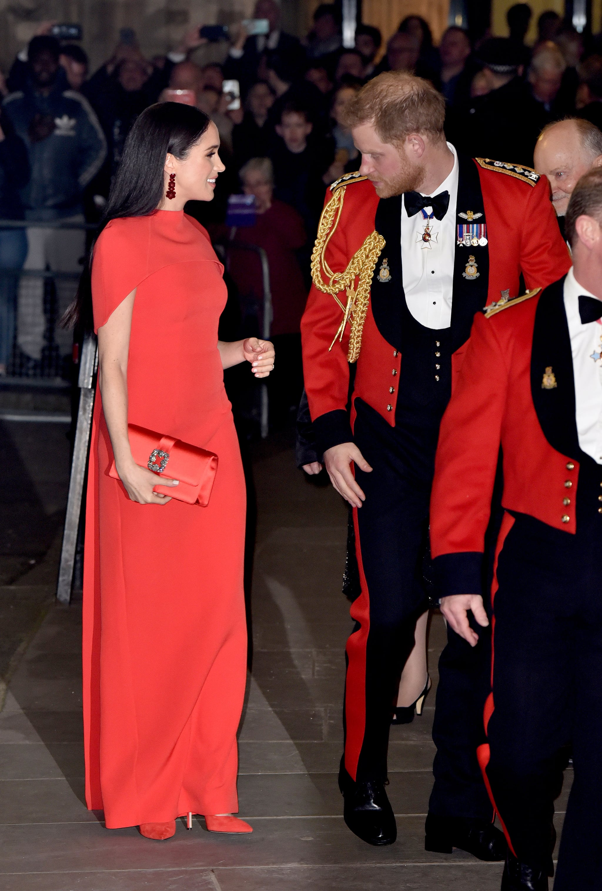 Meghan Markle At The Mountbatten Festival Of Music Meghan Markle Color Coordinates With Prince Harry In A Red Safiyaa Cape Dress Popsugar Fashion Photo 24