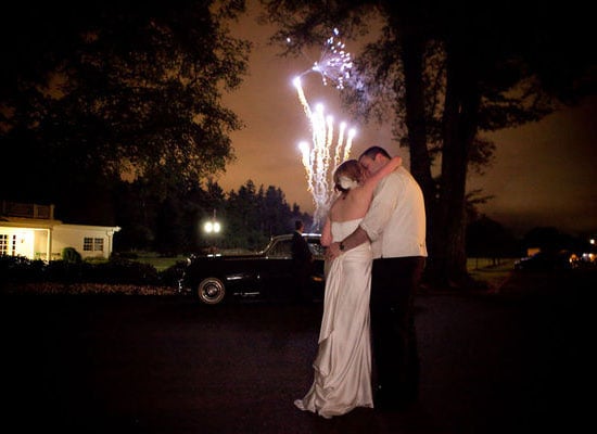 The happy couple stole a kiss during the fireworks at their Portland, OR, wedding.