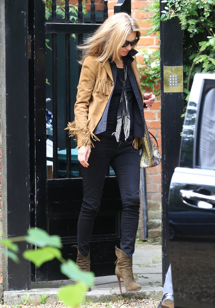 Kate Moss added major bohemian-cool flair to her London look via a tan fringe jacket.
