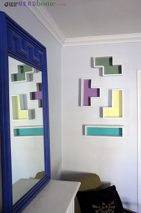 There are lots of online tutorials for how to make Tetris shelves. Most of the ones we found were a little more time-consuming complicated than what we wanted to do (we like to keep things pretty simple around here). By all means, if you plan to sell yours or gift them, you probably want to miter, dovetail, bevel, etc., but yeah . . . we skipped all that. Plus, we don't really have the necessary equipment for that kind of work.
For ours, we started with some 1/2-inch plywood that we had in the garage. A sheet of it is just over 10 bucks at Home Depot. We drew a grid on it, to be able to easily draw our Tetris shapes out. You know the ones. Making a grid like this means you don't have to measure your individual cuts (just count out the squares). Our grid squares were each 4 inches by 4 inches.