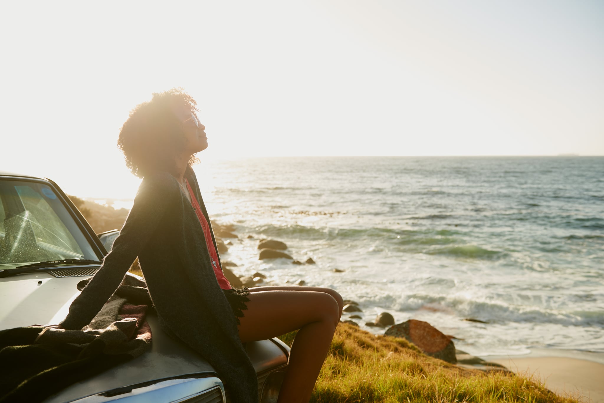 Shot of a young woman sitting on the hood of her car while on a roadtriphttp://195.154.178.81/DATA/istock_collage/a5/shoots/785271.jpg