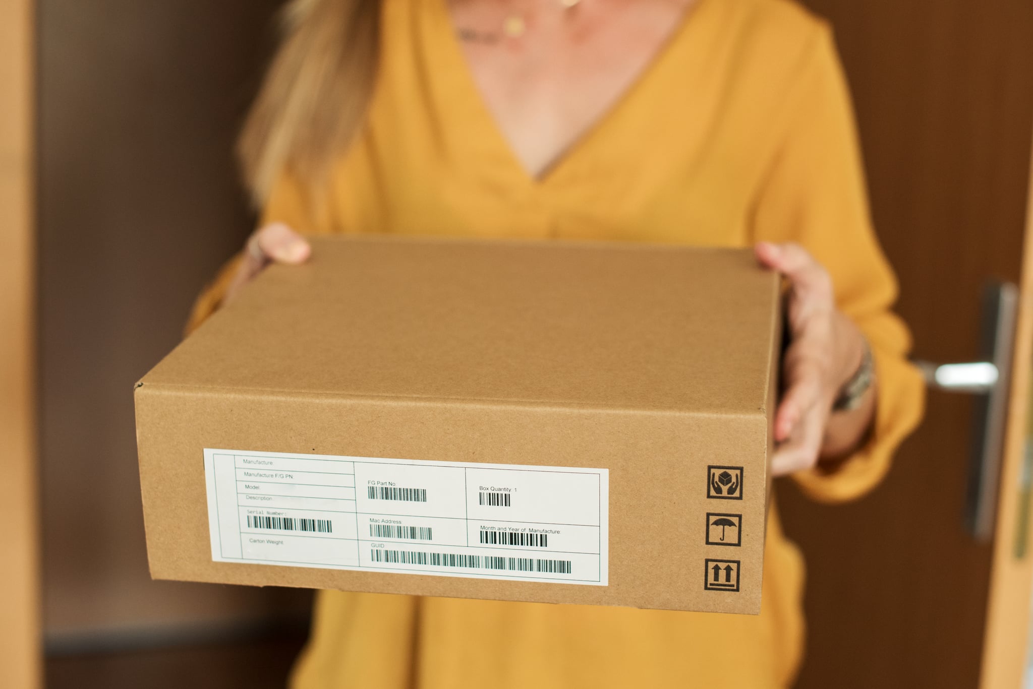 Close up of young woman receiving a package