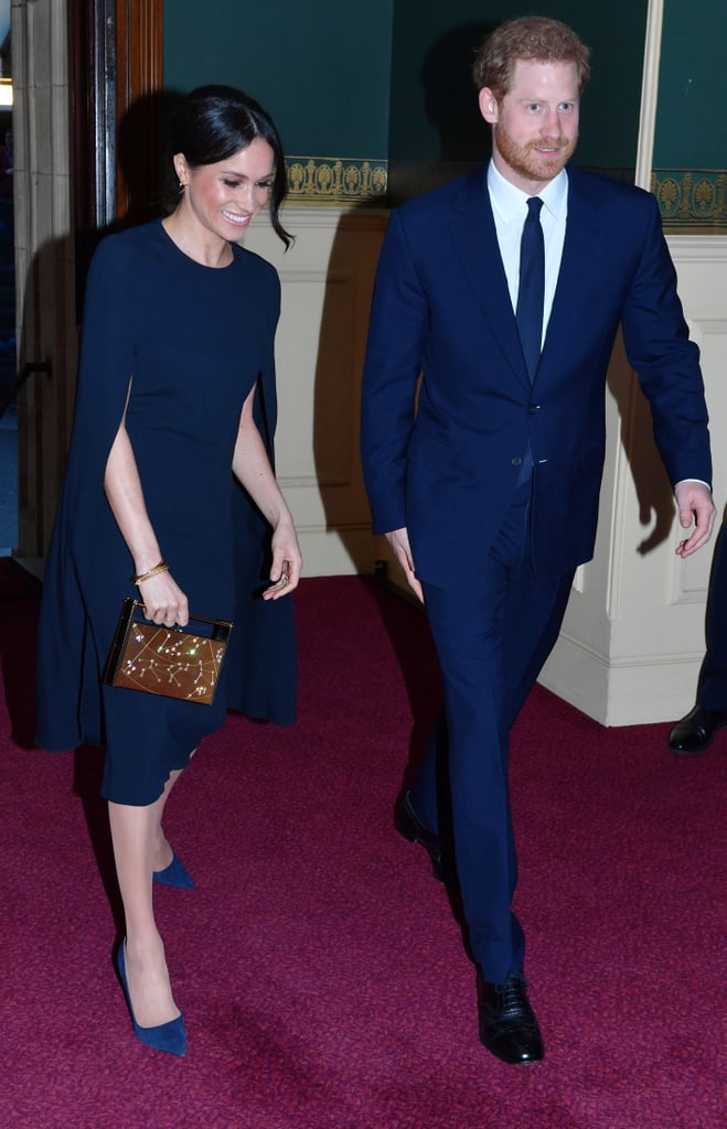 ‎Meghan Markle Carrying a Naeem Khan Armory Zodiac Clutch Bag in Leo Gold