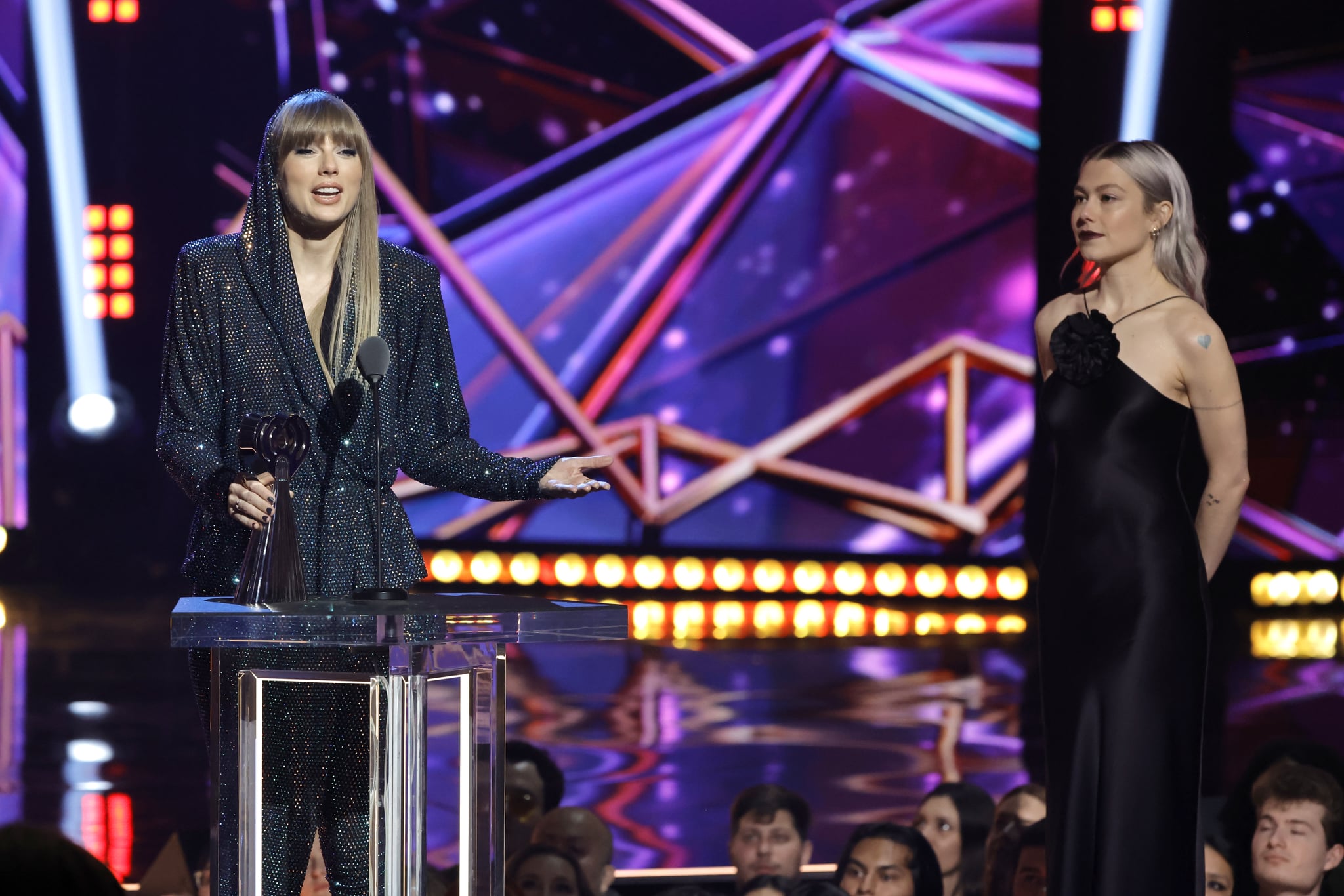 LOS ANGELES, CALIFORNIA - MARCH 27: (FOR EDITORIAL USE ONLY) (L-R) Honoree Taylor Swift accepts the iHeartRadio Innovator Award from Phoebe Bridgers onstage during the 2023 iHeartRadio Music Awards at Dolby Theatre in Los Angeles, California on March 27, 2023. Broadcasted live on FOX. (Photo by Kevin Winter/Getty Images for iHeartRadio)