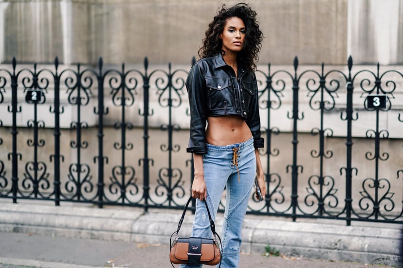 PARIS, FRANCE - FEBRUARY 28: Cindy Bruna wears a black leather crop jacket, blue lace up low waist jeans, a brown Prada bag, outside Redemption, during Paris Fashion Week Womenswear Fall/Winter 2019/2020, on February 28, 2019 in Paris, France. (Photo by E