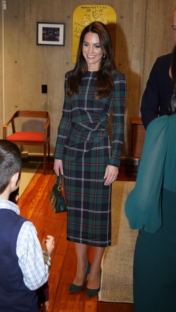 Kate Middleton wears a Burberry dress, Emmy London pumps, a Mulberry bag, and Shyla London earrings.