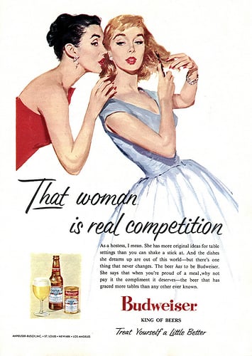 This 1956 ad hopes to convince housewives that Budweiser will help them win the competition for best hostess ever. The copy reads, "The beer has to be Budweiser. She says that when you're proud of a meal, why not pay it the compliment it deserves — the beer that has graced more tables than any other ever known."