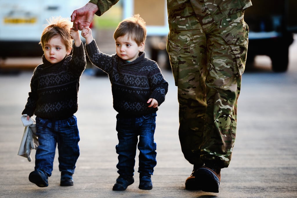 Two little boys held hands with their dad after he arrived.