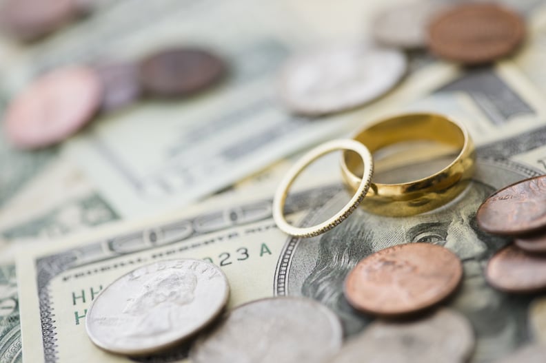 wedding rings on top of cash