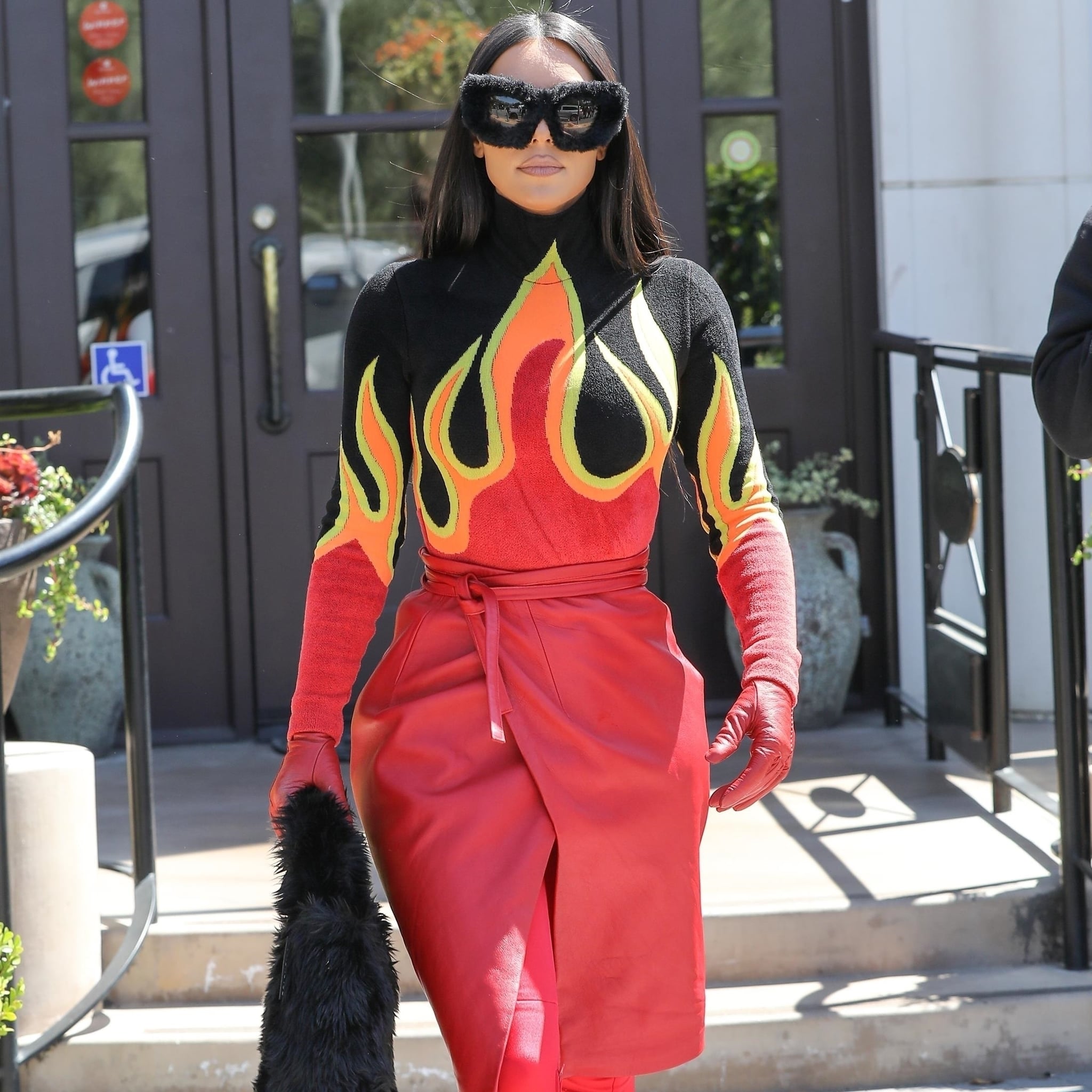Kim Kardashian Wears a Flame-Print Top and Fuzzy Accessories