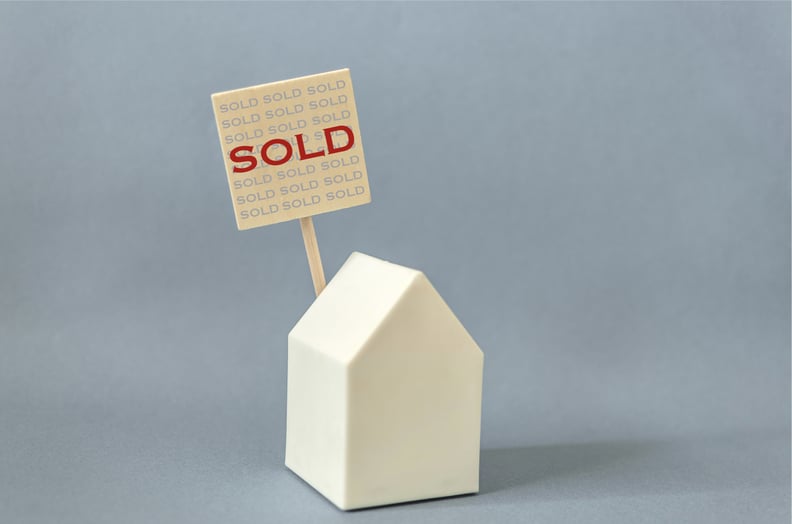 Close-up of House model with sold sign