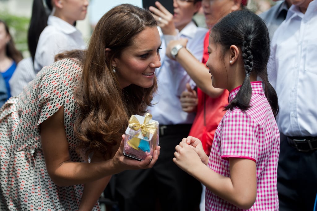 Kate graciously accepted a gift from a little girl during her September 2012 trip to Singapore. Kate graciously accepted a gift from a little girl during her September 2012 trip to Singapore.