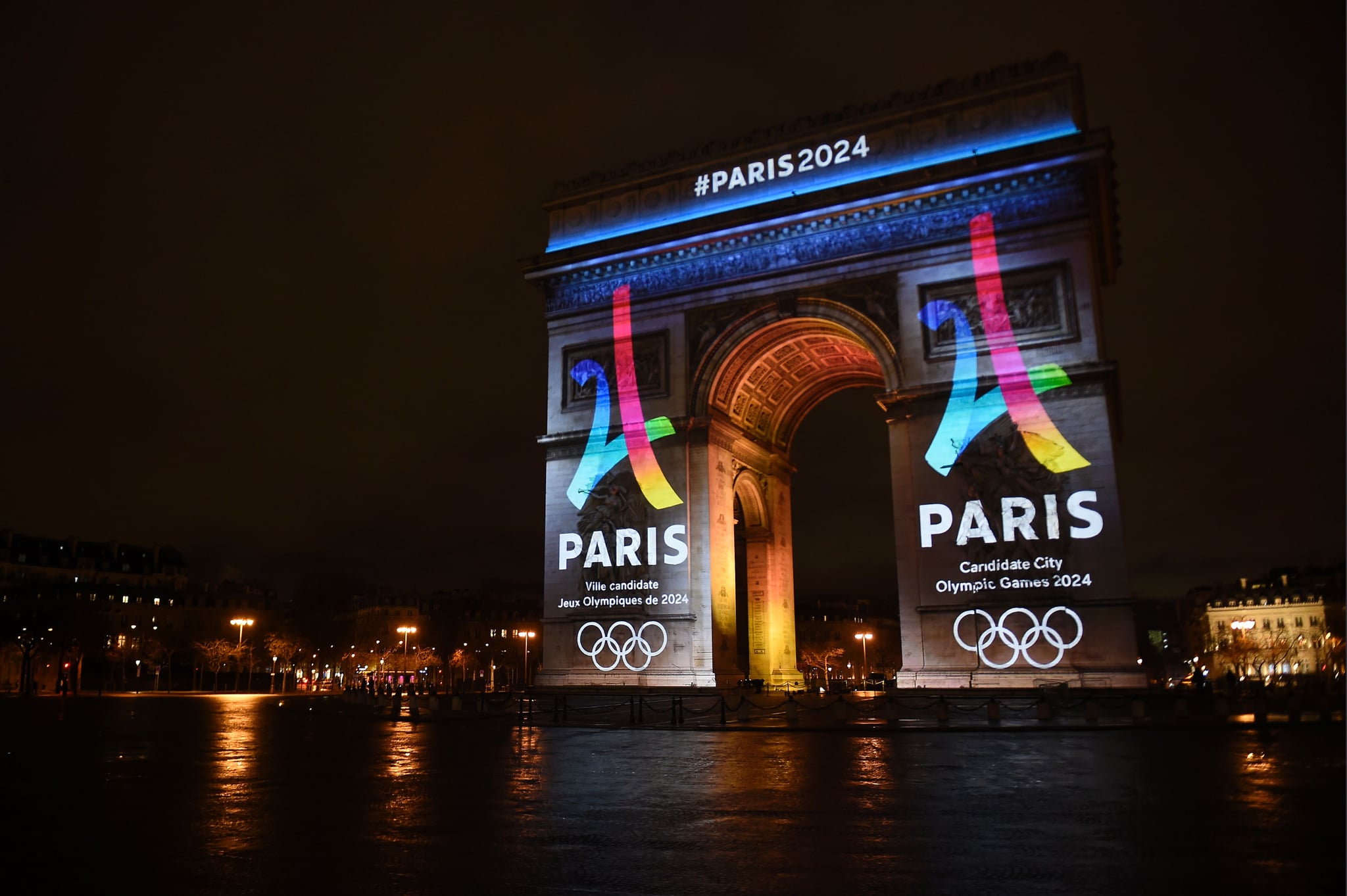 The campaign's official logo of the Paris bid to host the 2024 Olympic Games is seen on the Arc de Triomphe in Paris on February 9, 2016.  AFP PHOTO / LIONEL BONAVENTURE / AFP / LIONEL BONAVENTURE        (Photo credit should read LIONEL BONAVENTURE/AFP via Getty Images)