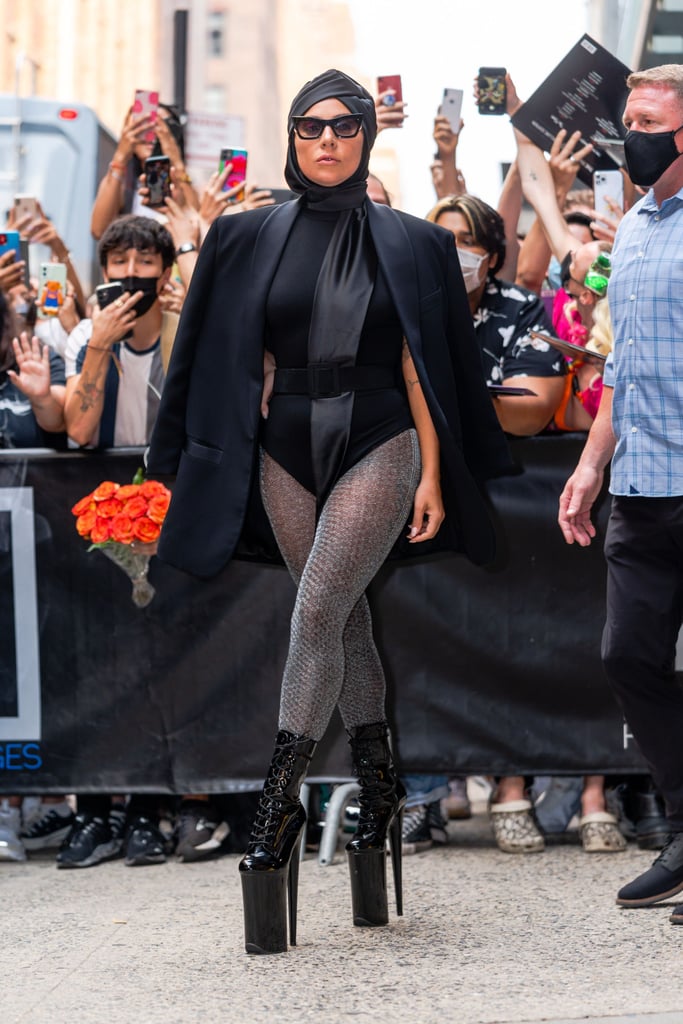 What. A. LOOK. Gaga said, "Who needs pants?" with this outfit, pairing a black bodysuit with an oversize blazer, glittery tights, and, of course, some dangerously high Pleaser boots for good measure.
