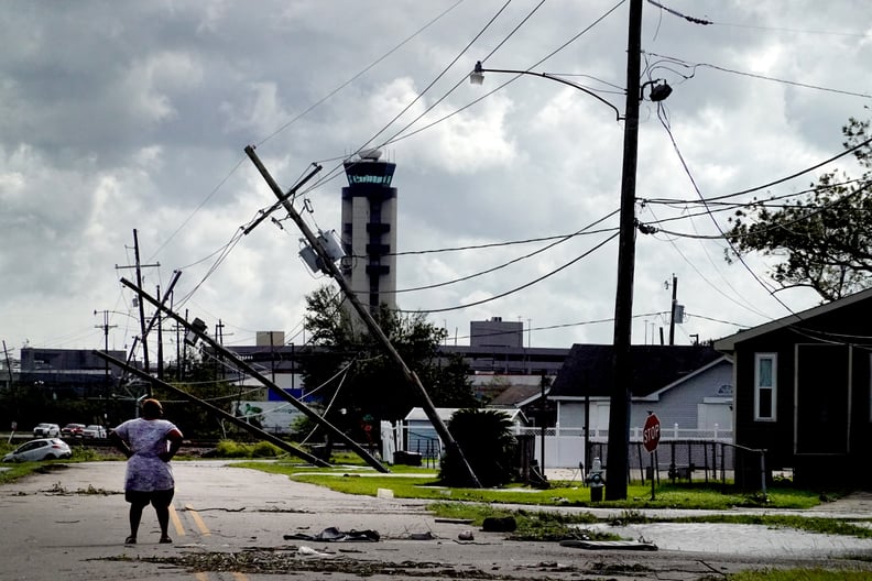 KENNER, LOUISIANA - AUGUST 30: A woman looks over damage to a neighborhood caused by Hurricane Ida on August 30, 2021 in Kenner, Louisiana. Ida made landfall yesterday as a category 4 storm southwest of New Orleans.  (Photo by Scott Olson/Getty Images)