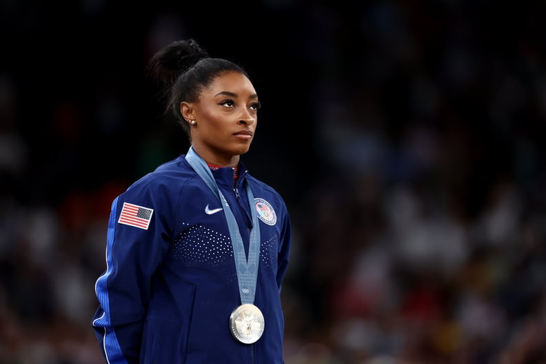 Simone Biles posing with her silver medal at the 2024 Paris Olympics