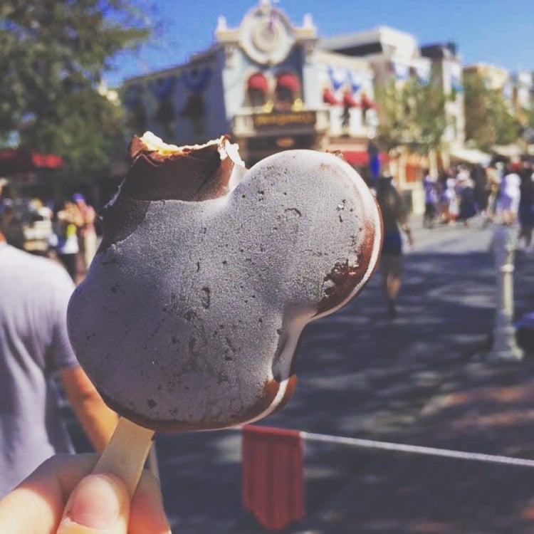 Treat yourself to iconic Mickey-shaped ice cream from an ice cream stand.