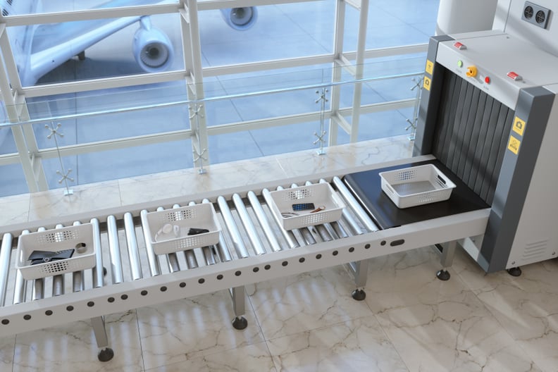 trays on conveyor belt at airport security checkpoint