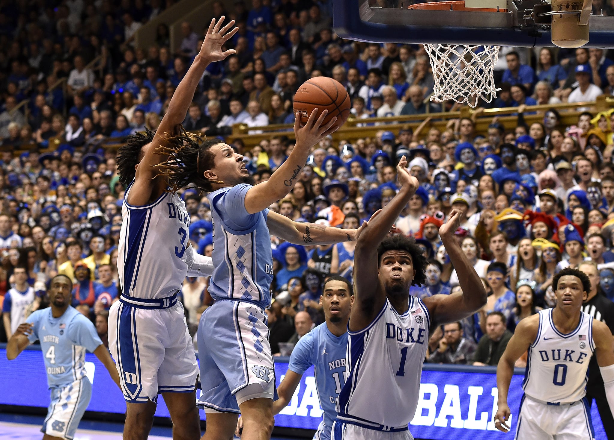 DURHAM, NORTH CAROLINA - MARCH 07: Cole Anthony #2 of the North Carolina Tar Heels drives between Tre Jones #3 and Vernon Carey Jr. #1 of the Duke Blue Devils during the second half of their game at Cameron Indoor Stadium on March 07, 2020 in Durham, North Carolina. Duke won 89-76. (Photo by Grant Halverson/Getty Images)