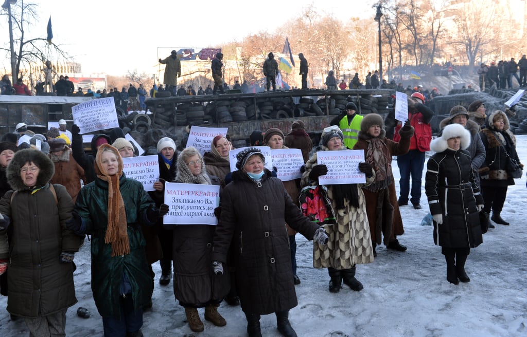 Women gathered with signs asking the police to join the protest.