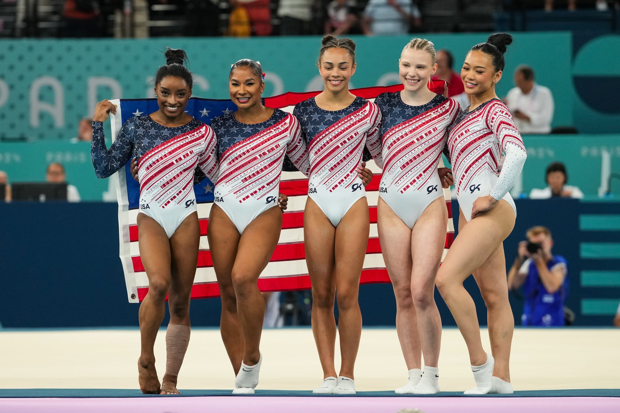PARIS, FRANCE - JULY 30: Simone Biles of United States, Jade Carey of United States, Jordan Chiles of United States, Sunisa Lee of United States and Healy Rivera  of United States celebrate on the podium for winning the gold medal during Women's Team Final of the Artistic Gymnastics on Bercy Arena during the Paris 2024 Olympics Games on July 30, 2024 in Paris, France. (Photo By Alvaro Diaz/Europa Press via Getty Images)