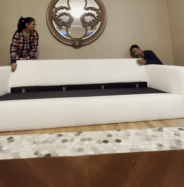 Man and woman assembling the Albany Park Barton Sofa.