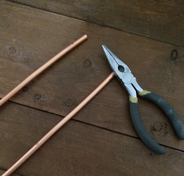After I cut the coil to the size I needed for each leg, I marked an inch down and then bent the coil with some pliers. This is the part that was later attached to the top using steel hanger tape.