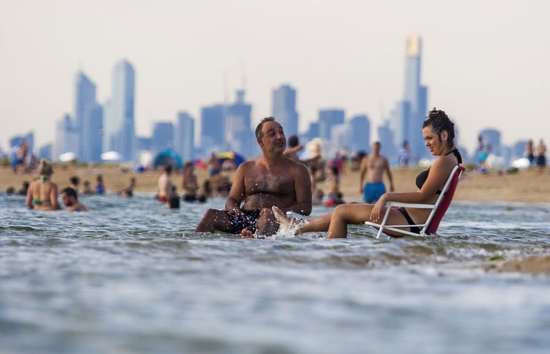 People have to sit in the water to survive the heat.