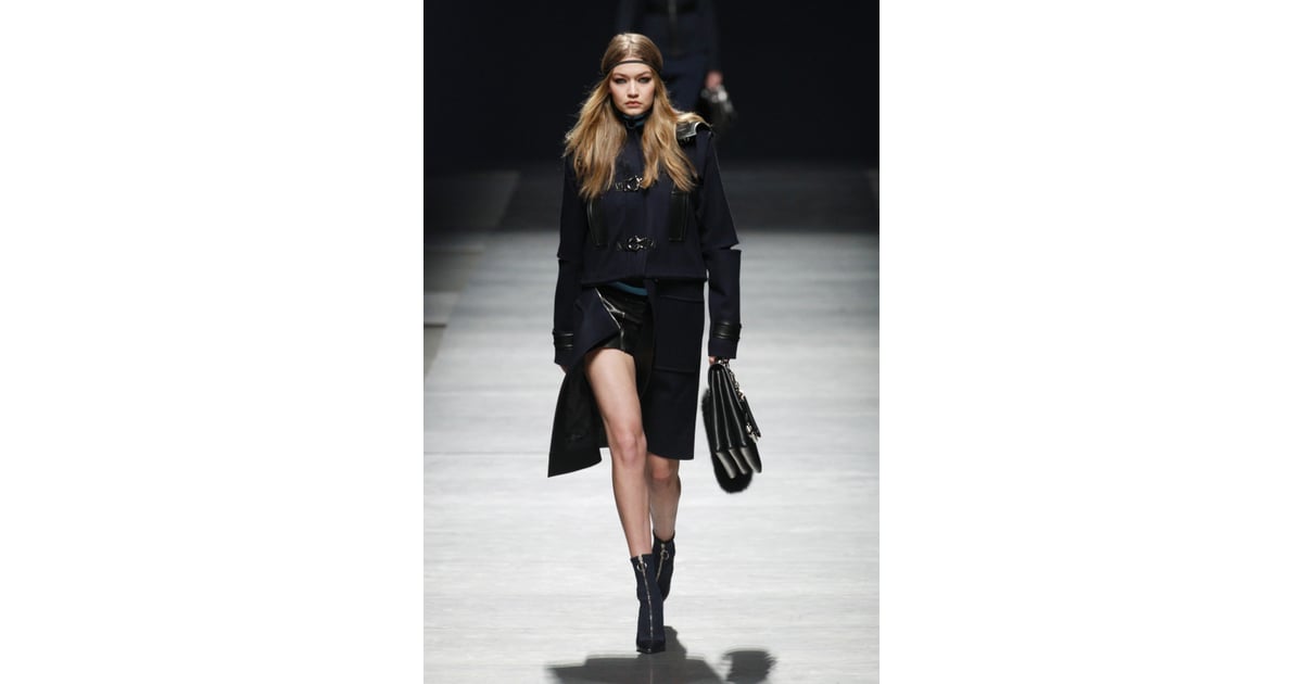 Gigi worked a structured navy and black coat with edgy cutouts and ...