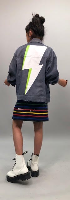 "Claudia's got this great jean jacket that she wears . . . it kind of fits her like a '90s vibe because it's oversize for her. We painted this lightning bolt on the back, but you never see it because on camera, we never see the back of it."