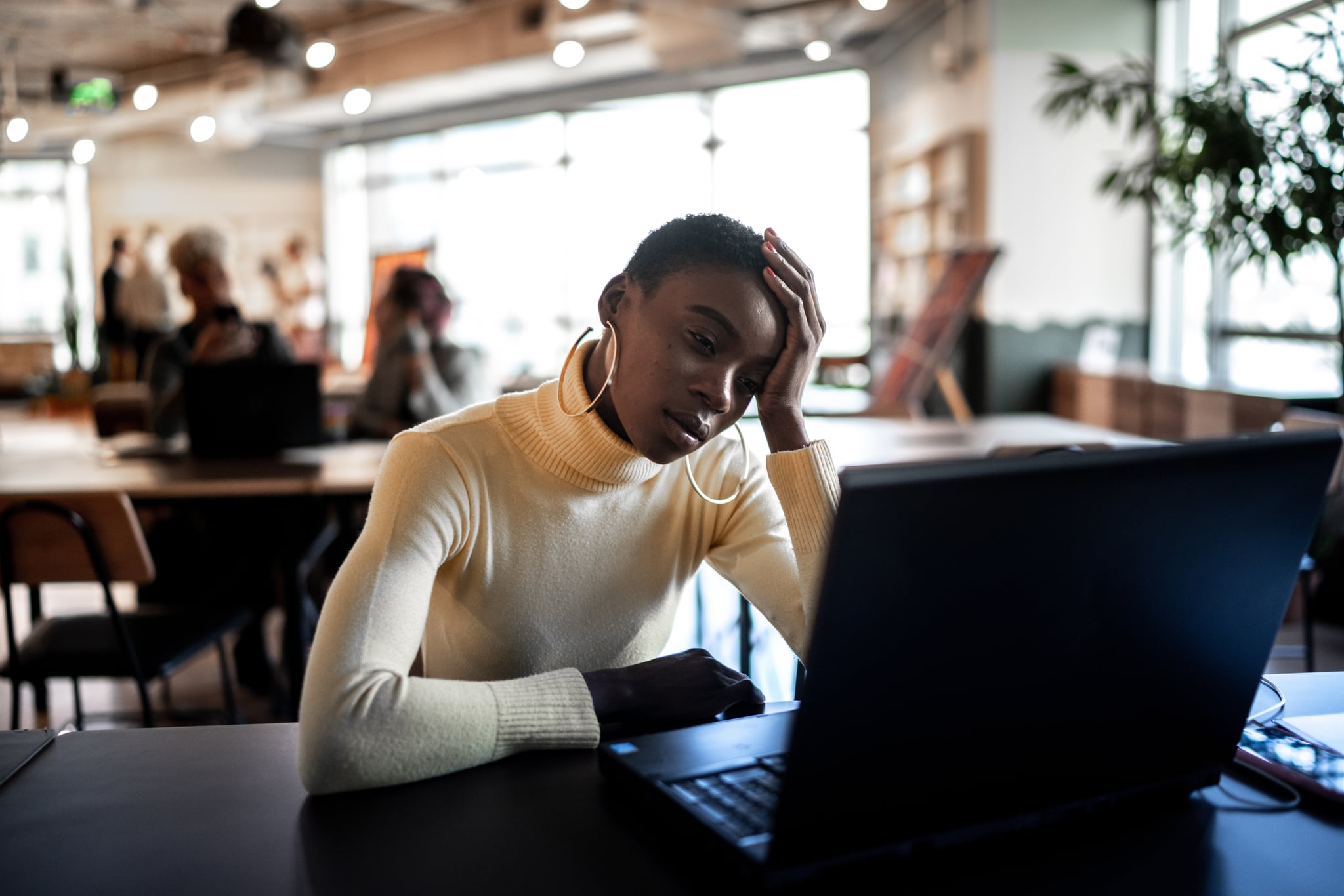 Worried businesswoman looking at laptop